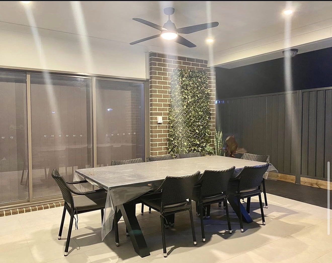Alfresco dining area with ceiling fan and downlights