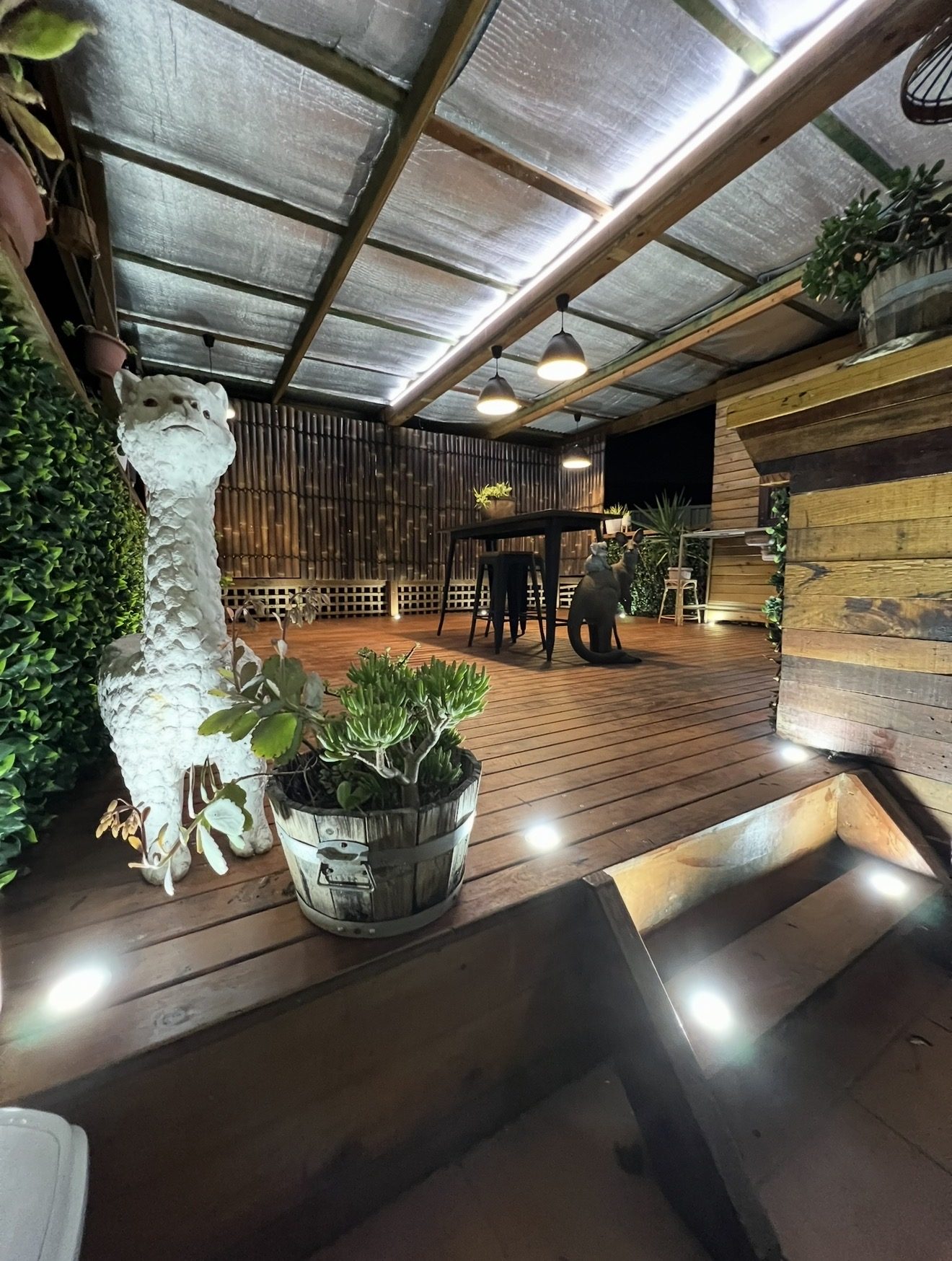 Covered deck with strip lighting, pendants and step lights